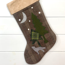 wolf Christmas stocking, stocking is brown plaid wool fabric, wolf is gray plaid wool fabric, moon is light gray wool fabric, two pine trees, tall tree is green wool fabric, short tree is green plaid wool fabric, five white vintage buttons, cuff is tea dyed cotton batting, rustic Christmas stocking, woodland Christmas stocking