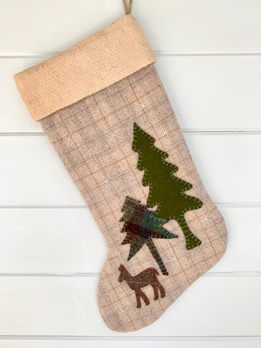 deer Christmas stocking, stocking is beige, tan plaid  wool fabric with a little blue mixed in, deer is brown plaid wool fabric, tall pine is green wool fabric, short pine tree is green plaid wool fabric, snowflakes are white and stitched onto the fabric, the trees and deer are hand stitched onto the stocking, cuff is tea dyed cotton batting, woodland deer Christmas stocking, rustic deer Christmas stocking, large Christmas stocking, woodland deer